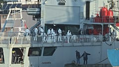 An Italian navy ship docks, as Italy sends 49 more migrants to Albania for processing following earlier court rejections, in the port of Shengjin, northwestern Albania, Tuesda
