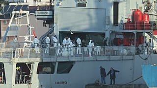 An Italian navy ship docks, as Italy sends 49 more migrants to Albania for processing following earlier court rejections, in the port of Shengjin, northwestern Albania, Tuesda