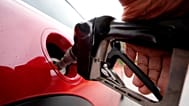 FILE - A motorist pumps petrol at a station in Englewood, Colorado, 5 July 2023