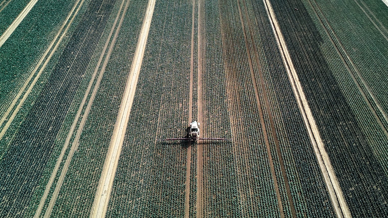 A farmer fertilises a field in the outskirts of Frankfurt, Germany, Wednesday, May 21, 2025.