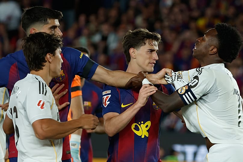Real Madrid's Vinicius Junior argues with Barcelona players during the Spanish La Liga soccer match between FC Barcelona and Real Madrid in Barcelona, 10 May, 2026