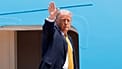 US President Donald Trump waves from the stairs of Air Force One as he boards at Joint Base Andrews, 12 May, 2026