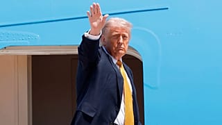 US President Donald Trump waves from the stairs of Air Force One as he boards at Joint Base Andrews, 12 May, 2026