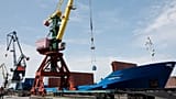 FILE: A crane unloads metal rolls from cargo ship Kholmogory arrived from St Petersburg at the port of Kaliningrad, 30 June 2022 