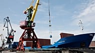 FILE: A crane unloads metal rolls from cargo ship Kholmogory arrived from St Petersburg at the port of Kaliningrad, 30 June 2022 