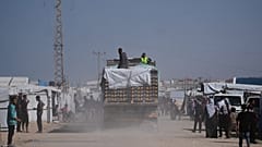 FILE: Trucks carrying food, after entering the Gaza Strip through the Kerem Shalom crossing, drive through Khan Younis, 1 February 2026