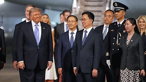 President Donald Trump pauses with China's Vice President Han Zheng during an arrival ceremony Wednesday, May 13, 2026, at Beijing Capital International Airport in Beijing.