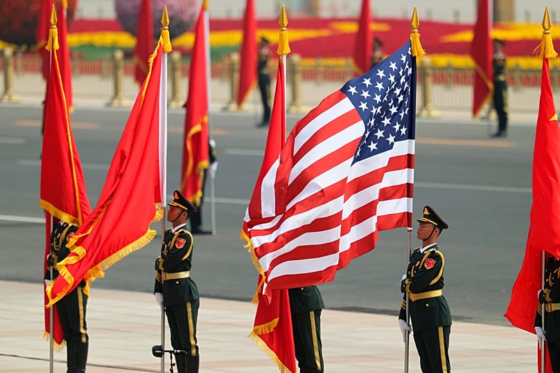 Chinese People's Liberation Army honour guards hold flags on the day of the welcome ceremony for US President Donald Trump in Beijing, 14 May, 2026