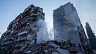 Rescue workers clear the rubble of a house heavily damaged after a Russian strike on a residential neighborhood in Kyiv, Ukraine, on Thursday, May 14, 2026