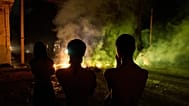 People look at a barricade set up by residents protesting against prolonged power outages in Havana, 13 May, 2026