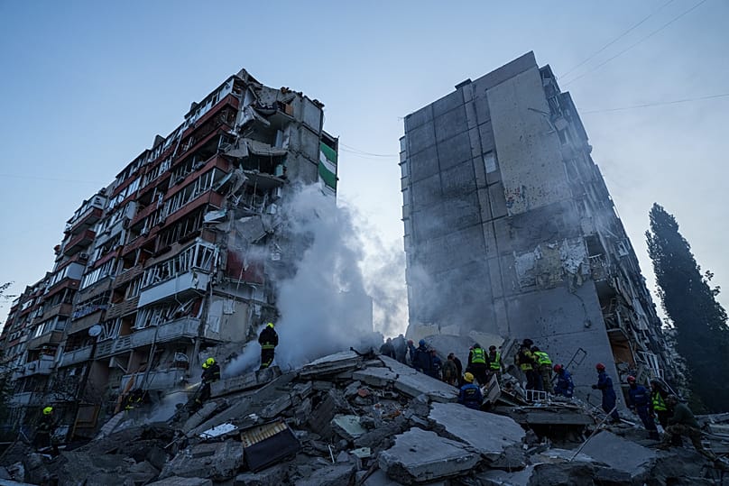 Rescue workers clear the rubble of a house heavily damaged after a Russian strike on residential neighbourhood in Kyiv, 14 May, 2026