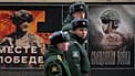 FILE: A military patrol passes by a street exhibition of military posters dedicated to Russian army in St Petersburg, 24 February 2025
