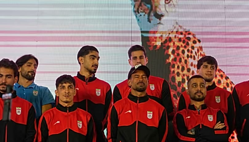 Iran's national soccer team players stand onstage as they are greeted by a crowd during a pro-government gathering before their departure for training and friendly matches in 