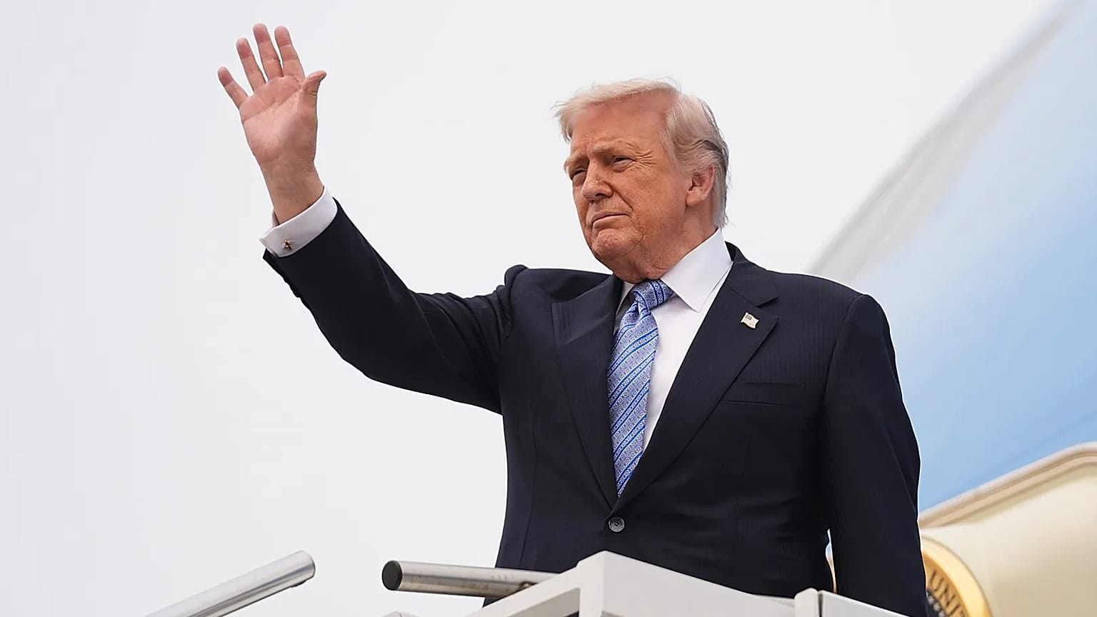 US President Donald Trump waves as he boards Air Force One at Beijing Capital International Airport, 15 May, 2026