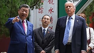 President Donald Trump walks with China's President Xi Jinping at the Zhongnanhai leadership compound, Friday, May 15, 2026, in Beijing.