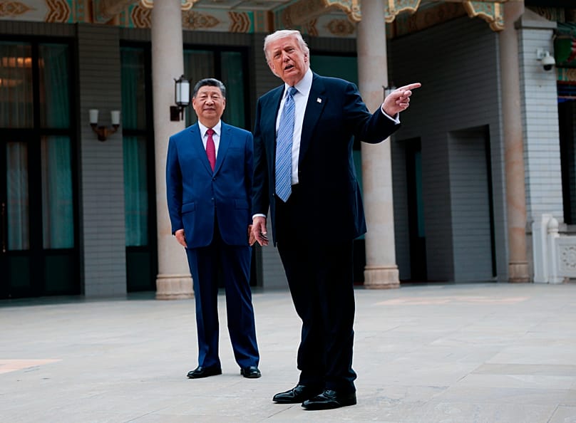 US President Donald Trump gestures as he speaks next to Chinese President Xi Jinping during a visit to the Zhongnanhai Garden in Beijing, 15 May, 2026