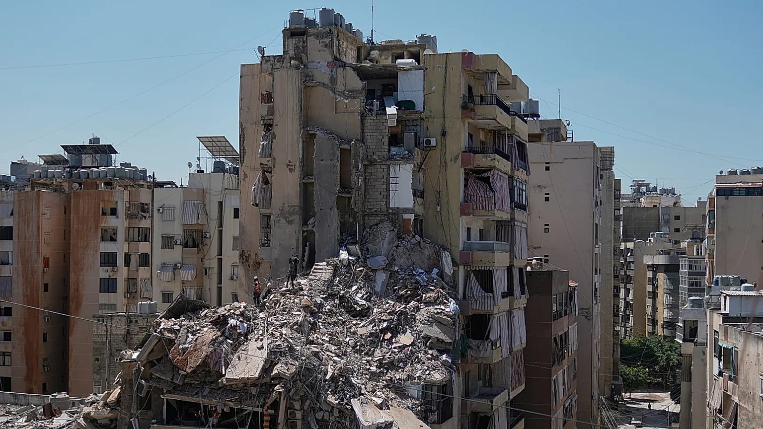 Rescue workers search through the rubble of a building destroyed in an Israeli airstrike the previous day in Dahiyeh, Beirut's southern suburbs, Lebanon, Thursday, May 7, 2026