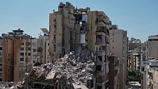 Rescue workers search through the rubble of a building destroyed in an Israeli airstrike the previous day in Dahiyeh, Beirut's southern suburbs, Lebanon, Thursday, May 7, 2026