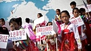 North Korean girls hold up signboards with the names of participating countries during an opening ceremony at the Songdowon International Children's Camp, 29 July, 2014