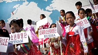 North Korean girls hold up signboards with the names of participating countries during an opening ceremony at the Songdowon International Children's Camp, 29 July, 2014