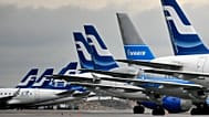 Passenger planes of the Finnish national airline company Finnair stand on the tarmac at Helsinki international airport, 16 November, 2009
