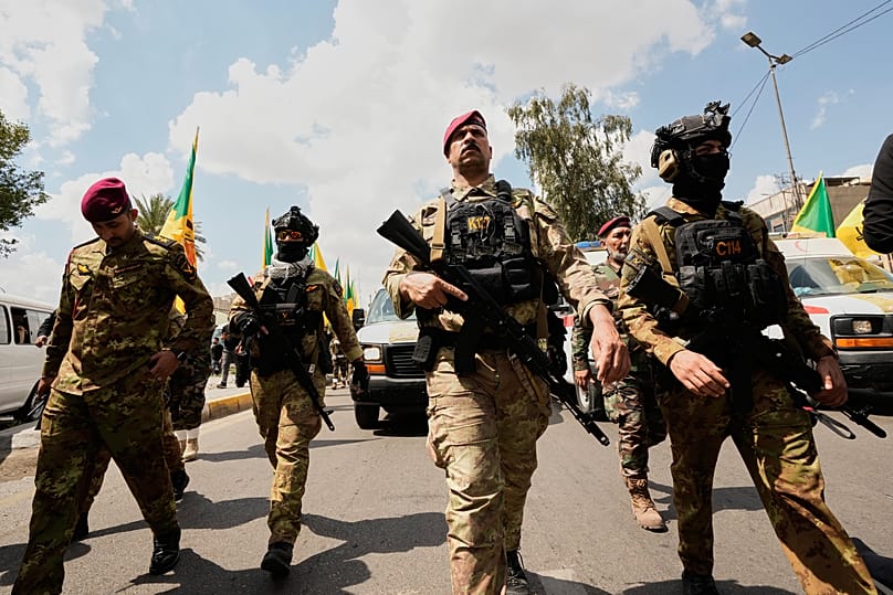 FILE: Members of an Iraqi Shiite militant group attend the funeral of a Kataib Hezbollah fighter who was killed in a US airstrike south of Baghdad, 8 April 2026