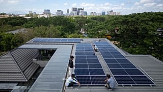 A team of solar installers set up a new rooftop solar system at a home in Manila, Philippines, on May 1, 2026. 