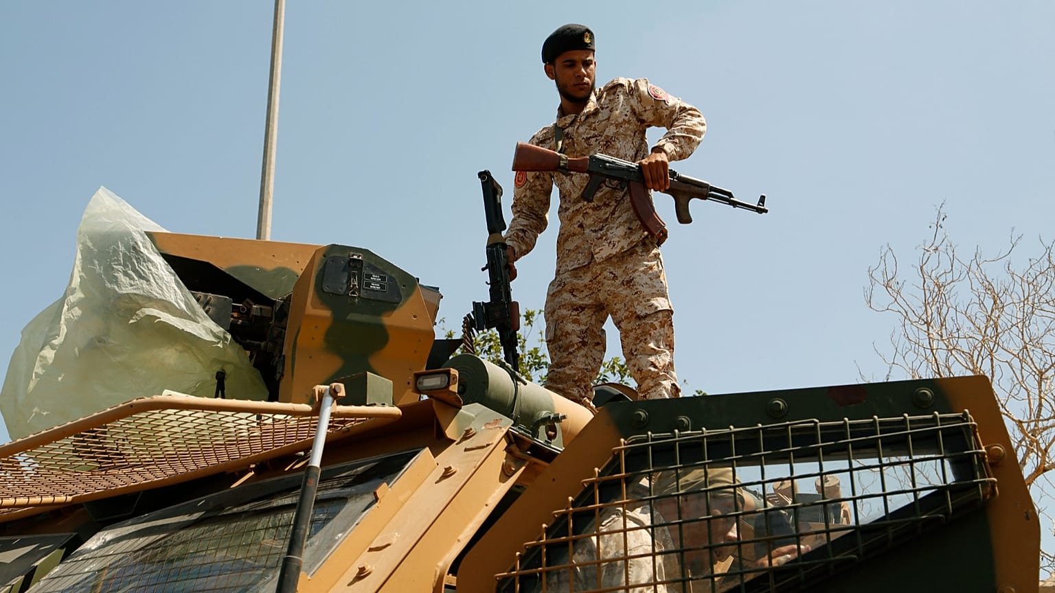 FILE: Libyan army forces and vehicles are stationed in a street in the country’s capital of Tripoli, 22 July 2022