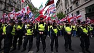 Police forces stand in front of the far right Unite the Kingdom march in London, Saturday, May 16, 2026.