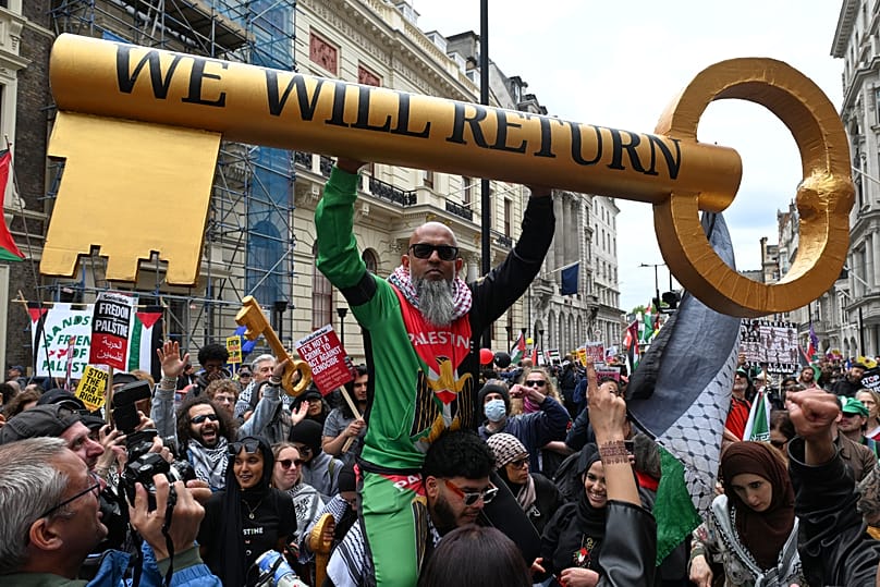 A protester show a giant key during a Pro-Palestine march in London, Saturday, May 16, 2026.