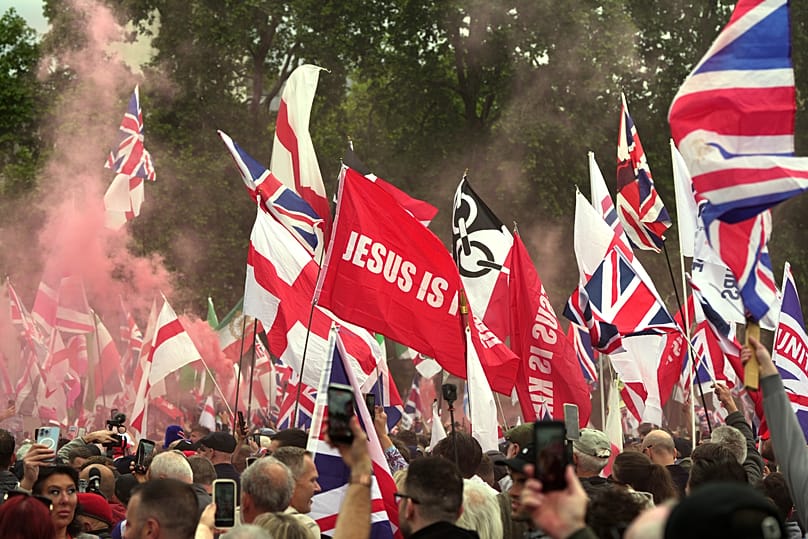 Protesters with flags gather during the far right Unite the Kingdom march in London, Saturday, May 16, 2026.