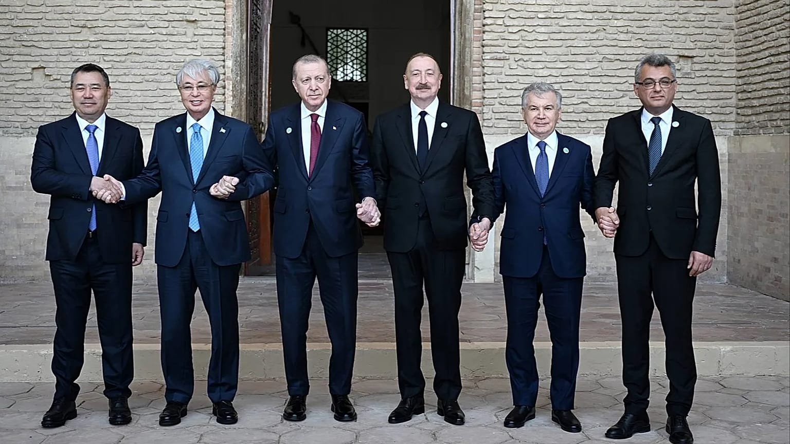 Presidents of Organisation of Turkic States members hold hands in front of mausoleum of Khoja Ahmed Yasawi, in Turkistan, Kazakhstan, 15 May 2026