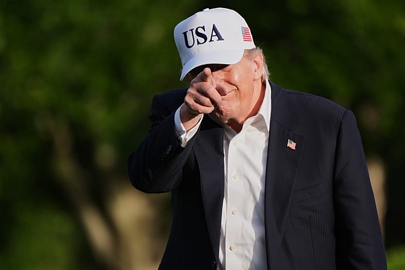 US President Donald Trump gestures to reporters as he walks across the South Lawn of the White House, 15 May, 2026
