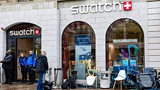 Swiss police officers secure the area where customers queue to buy the new Royal Pop watch by Swatch and Audemars Piguet, in Geneva, Switzerland, Saturday, May 16, 2026