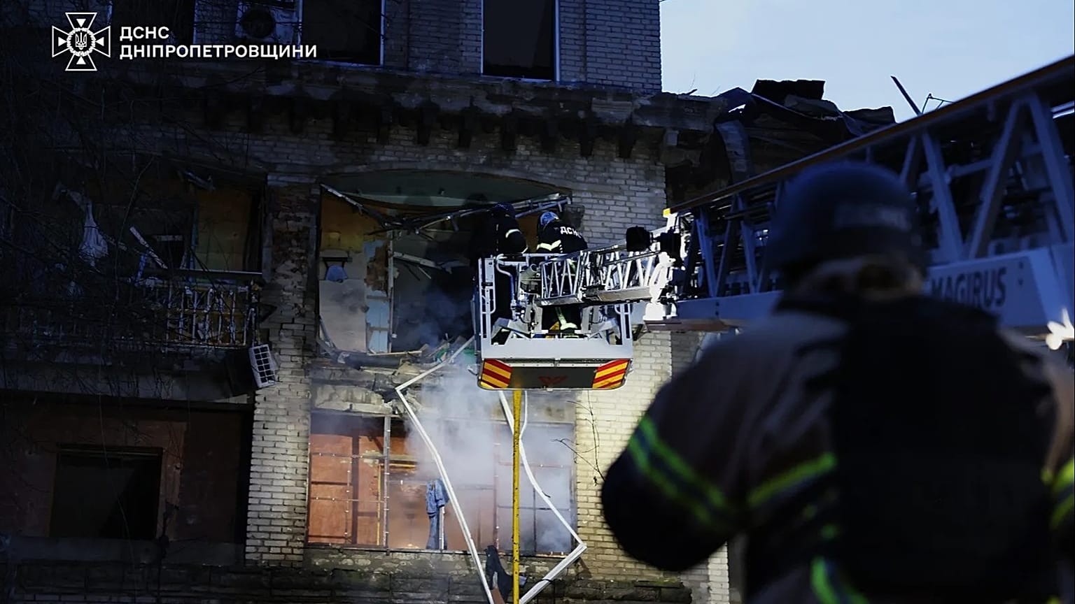 Rescue workers put out a fire of a residential building damaged after a Russian strike on Dnipro, 18 May, 2026