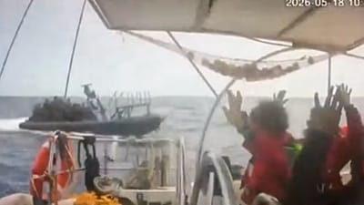 This grab from CCTV footage shows activists aboard a flotilla boat with their hands in the air as a boat approaches one of more than 50 vessels that departed from the port of 