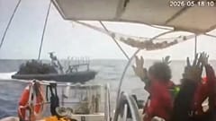 This grab from CCTV footage shows activists aboard a flotilla boat with their hands in the air as a boat approaches in international waters, 18 May, 2026