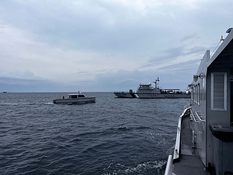 A coastguard boat and other vessels deployed to search for the four missing Italian divers near Alimathaa Island, Vaavu Atoll, Maldives, Saturday, May 15, 2026