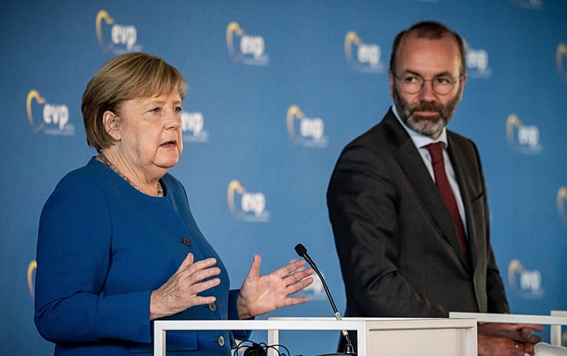 German Chancellor Angela Merkel speaks next to Manfred Weber during a press conference in Berlin, Sept. 9, 2021. (Michael Kappeler/dpa via AP) 