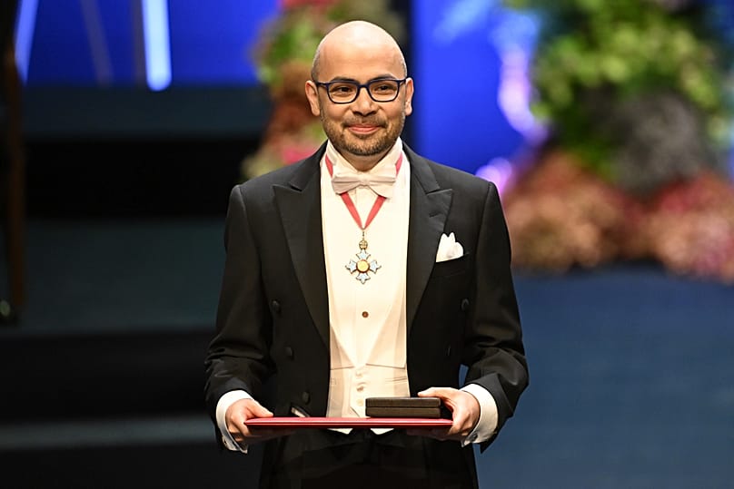 FILE. Demis Hassabis holds his Nobel laureate in chemistry during the Nobel Prize ceremony in Stockholm, Sweden, Dec. 2024