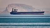 FILE: A bulk cargo ship sits at anchor in the Strait of Hormuz off Bandar Abbas, 2 May 2026