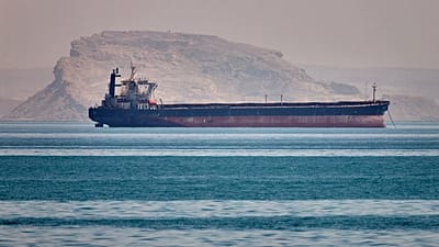 FILE: A bulk cargo ship sits at anchor in the Strait of Hormuz off Bandar Abbas, 2 May 2026