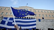 A pro-Euro demonstrator waves a European Union flag outside the Greek Parliament during a rally in Athens, Monday, June 22, 2015. Thousands of people gathered to show support 