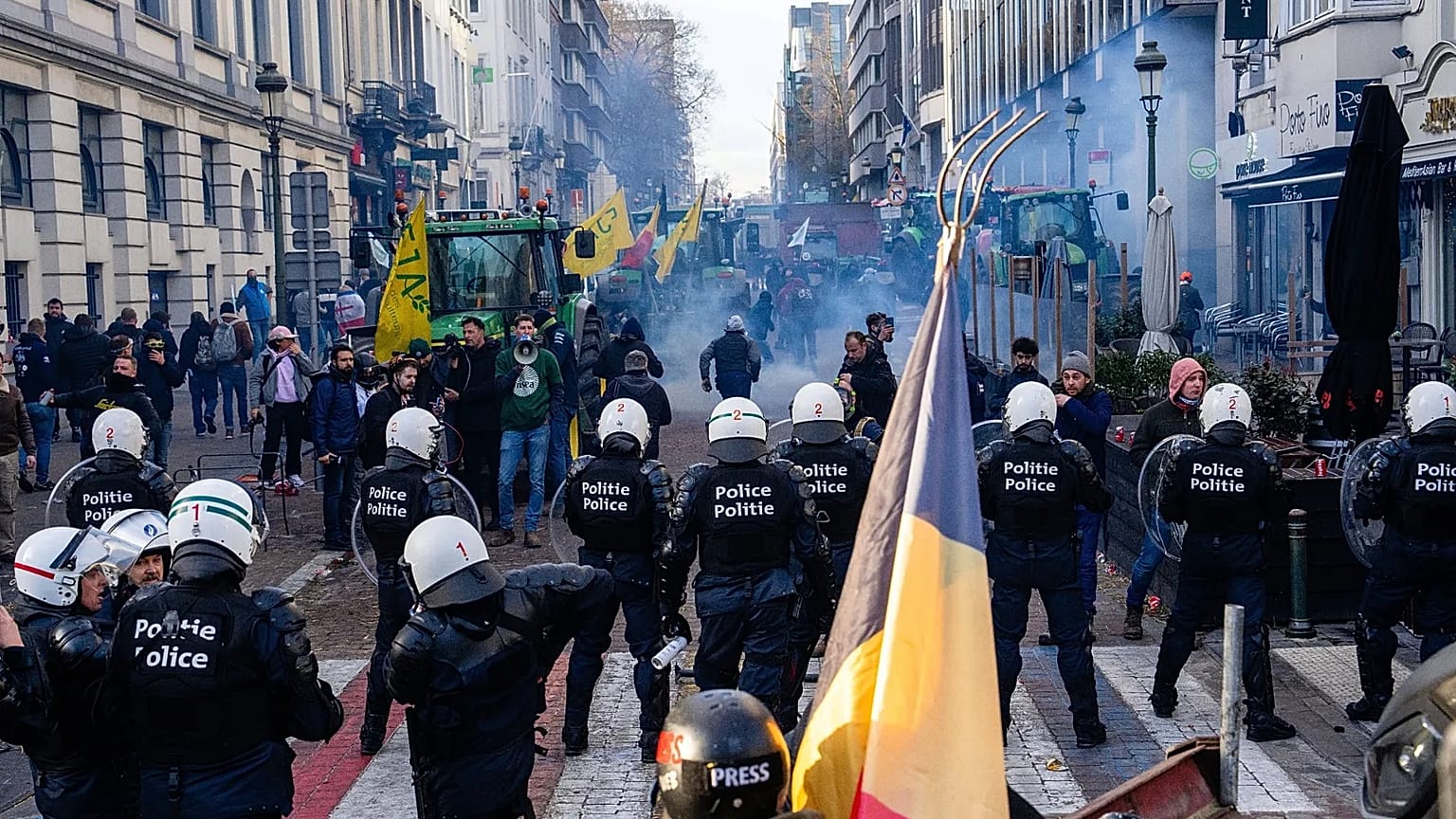 Police try to disperse protestors during a demonstration of European farmers near the European Parliament in Brussels, Thursday, Dec. 18, 2025.