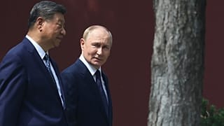 FILE: Vladimir Putin and Xi Jinping during a walk at the Zhongnanhai leadership compound in Beijing, China, Sept. 2, 2025.