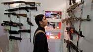 FILE: An Iranian man looks at guns as he visits a security equipment exhibition organised by the police at the Grand Mosque in Tehran, 24 September 2012