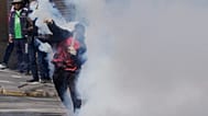 A protester returns a tear gas canister to police during an anti-government protest in La Paz, Bolivia, Monday, May 18, 2026.