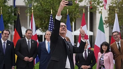 French Finance Minister Roland Lescure takes a selfie picture as G7 Finance Ministers and Central Bank Governors pose for a family photo at the G7 finance meeting in Paris