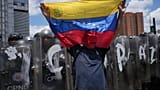 A man holds a Venezuela flag during a protest in Caracas, Venezuela, Monday, May 18, 2026, calling for justice after Carmen Navas’ death.