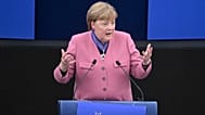 Former German Chancellor Angela Merkel delivers a speech after receiving the European Order of Merit